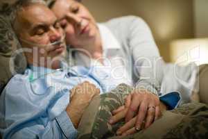 Retired ill man and caring wife sleeping