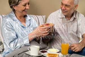 Senior couple having romantic morning breakfast