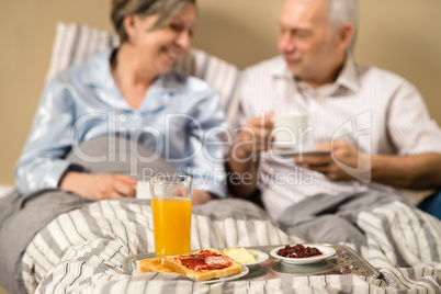 Pensioners drinking coffee in the bed