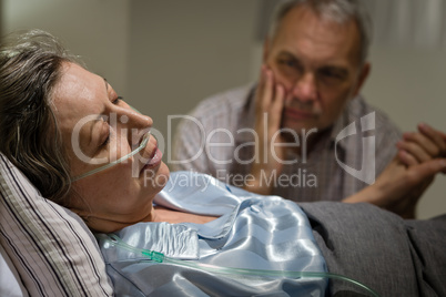 Sick mature woman lying in bed