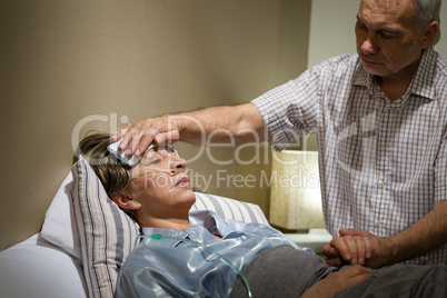 Caring senior man helping his sick wife