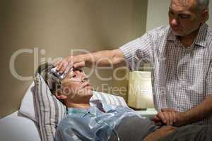 Caring senior man helping his sick wife