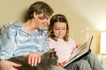 Grandmother and girl looking at photo album