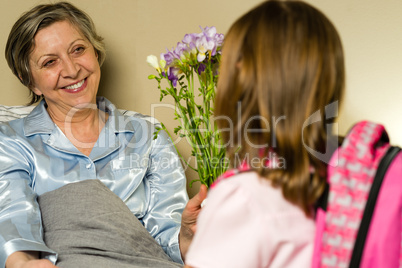 Little girl visiting her ill grandmother