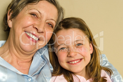 Portrait of smiling grandmother and granddaughter