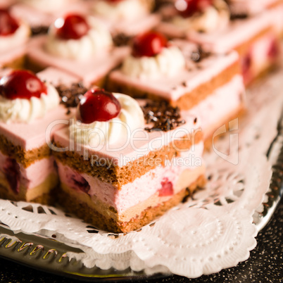 Cherry cream filled sponge cakes with topping