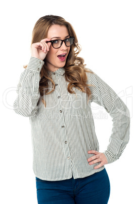 Young woman adjusting her spectacles