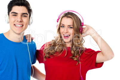 Adorable young couple enjoying music