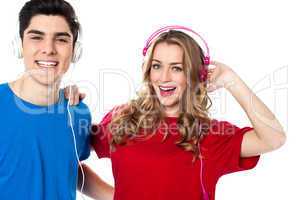 Adorable young couple enjoying music