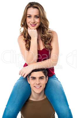 Pretty girl sitting on the shoulders of her boyfriend