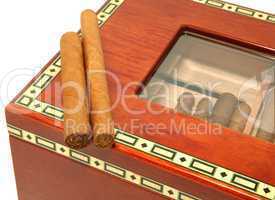 Two cigars on a humidor box