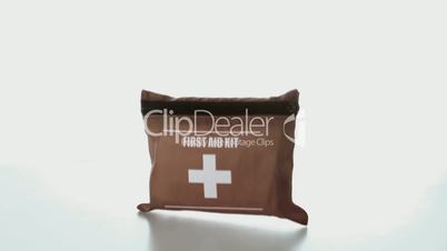 First aid kit falling on white background