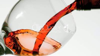 Red wine pouring into glass low angle view