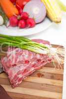 chopping fresh pork ribs and vegetables