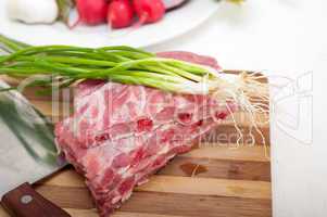 chopping fresh pork ribs and vegetables