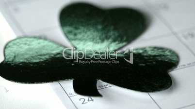 Large shamrock falling on calendar marking st patricks day