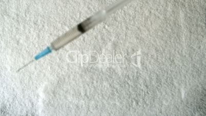 Needle falling into pile of sugar