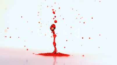 Red ink bouncing on vibrating surface