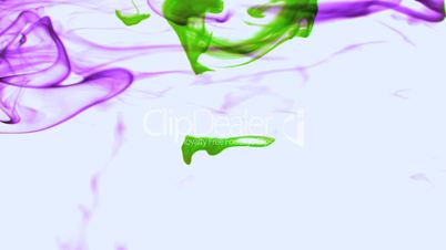 Purple and green ink swirling in water