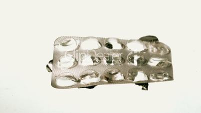 Empty blister pack of tablets falling and hovering mid air