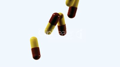 Red and yellow capsule tablets dropping and bouncing