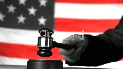 Judge calling order with gavel in american court in selective black and white