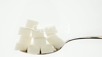 Pile of sugar lumps appearing on teaspoon