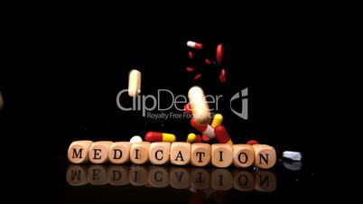 Pills falling and rolling over dice spelling medication