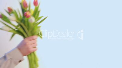 Man placing tulips in vase
