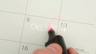 Man circling mothers day on calendar and laying down tulip