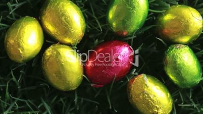 Easter eggs packed in aluminium in the grass