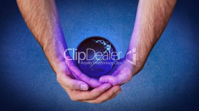 Hands holding a purple planet that reveal chroma key screen