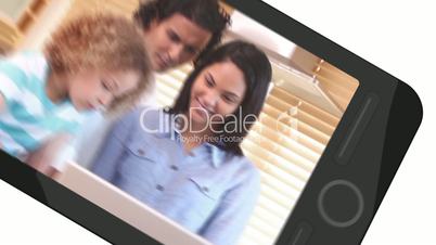 Smarphone screens showing family using laptop