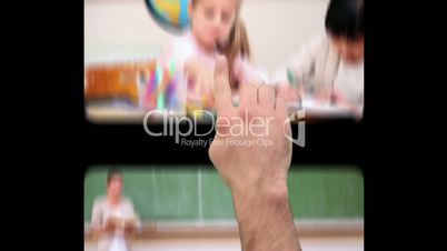 Hand using screens with children at school