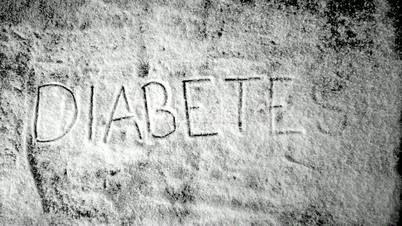 Diabetes written into sugar powder being blown away