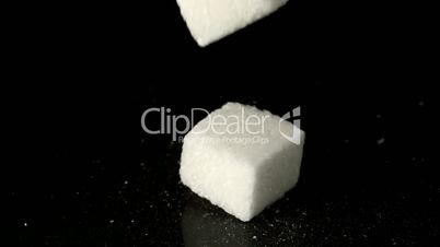 Sugar cubes falling on hard surface