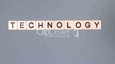 Plastic letters bouncing and spelling out technology