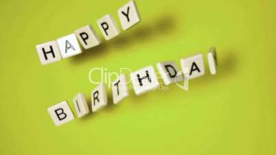 Plastic letters bouncing and spelling out happy birthday