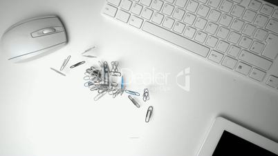 Group of paperclips spilling onto office desk