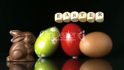 Dice spelling out easter falling in front of easter treats and egg