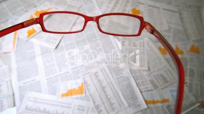 Glasses falling on papers