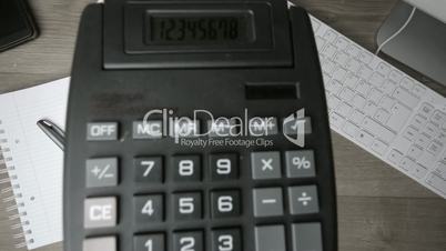 Calculator falling on office desk in black and white