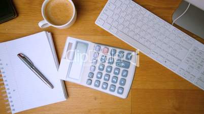 Pocket calculator falling on office desk