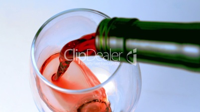 High angle shot of red wine being poured into glass
