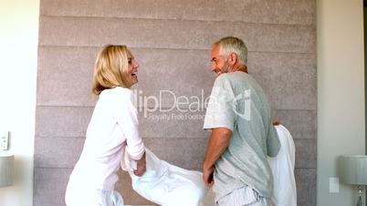 Mature couple having a pillow fight