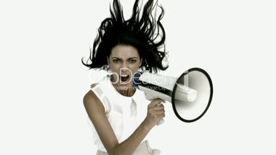 Angry businesswoman shouting on megaphone and jumping