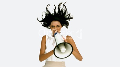 Angry businesswoman shouting on megaphone and jumping up