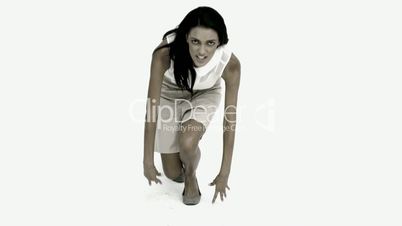 Businesswoman ready to race on white background