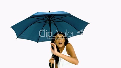 Pretty woman under blue umbrella cowering with fear