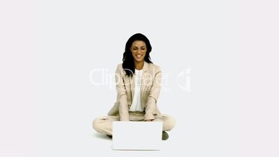 Woman cheering in front of laptop